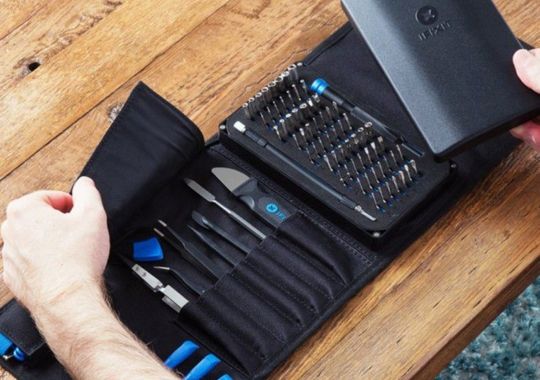 A person unboxing the ifixit pro tech toolkit.